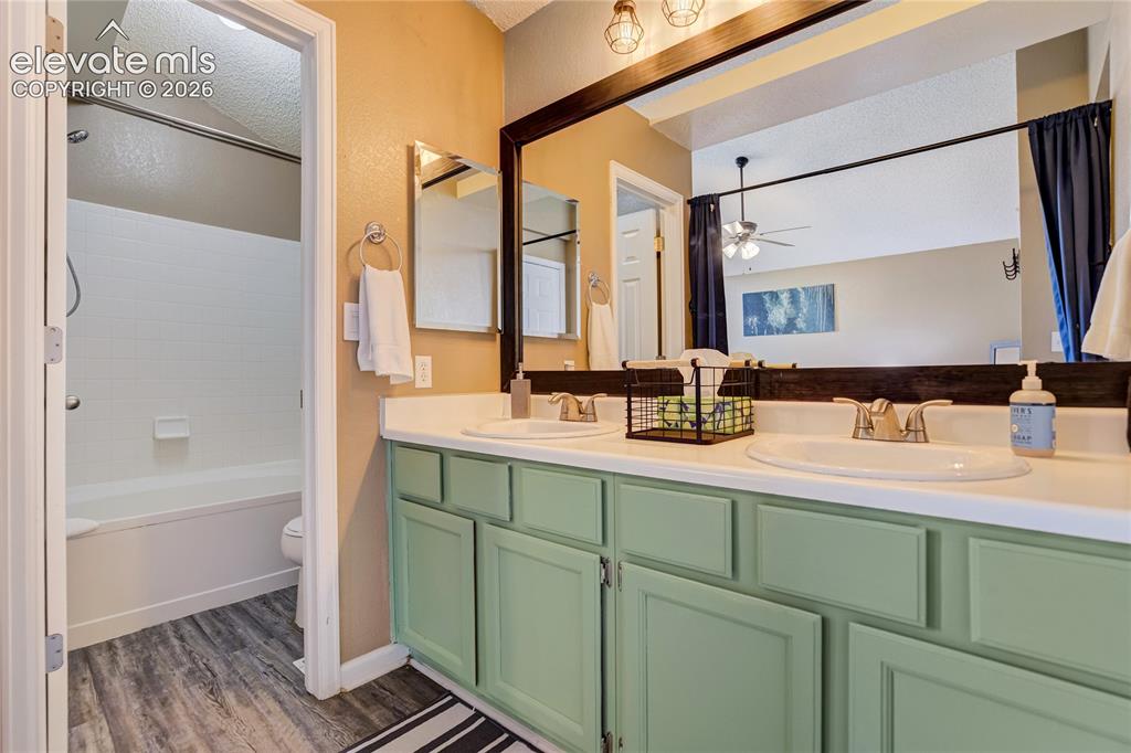 Image 21 of 40: Double vanity with light green cabinetry and white countertops