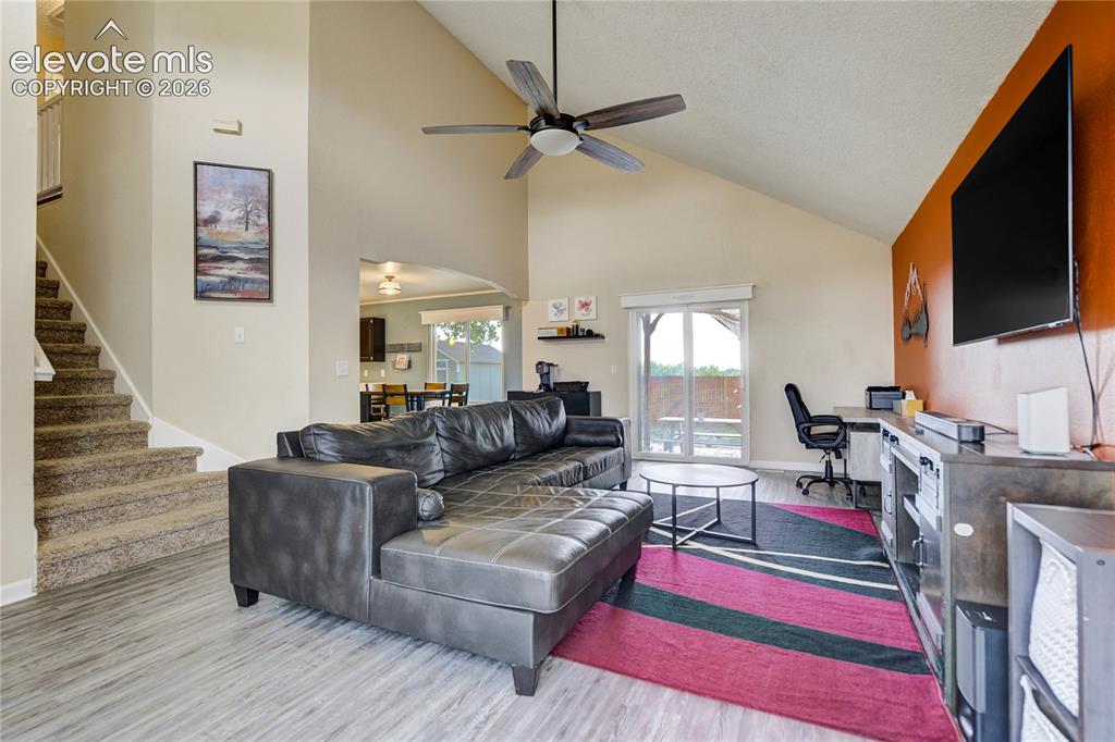 Image 3 of 40: Great room featuring vaulted ceilings, wood-finish flooring, a contemporary
