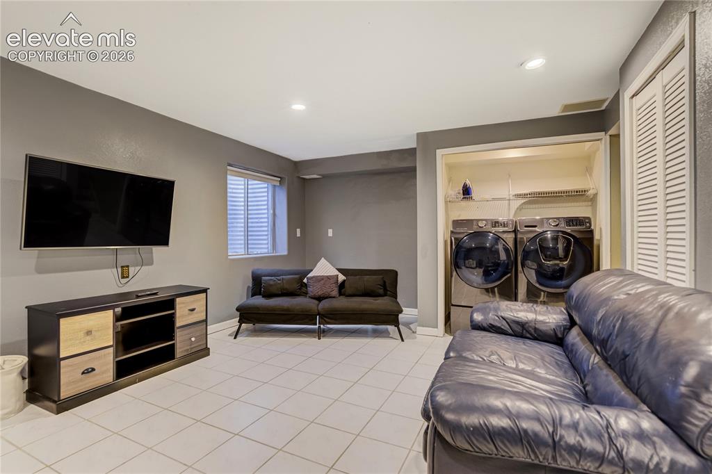Image 35 of 40: Versatile room featuring tile flooring, recessed lighting, and a window wit