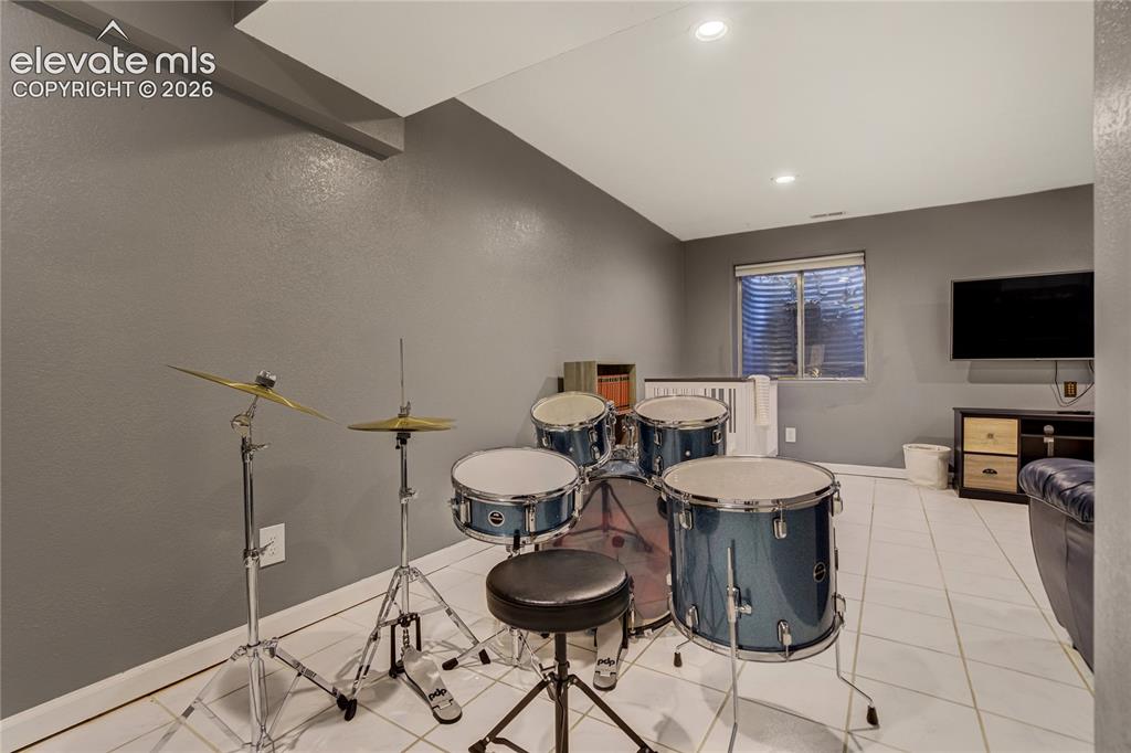 Image 37 of 40: Finished lower level room featuring recessed lighting, a window, and light-