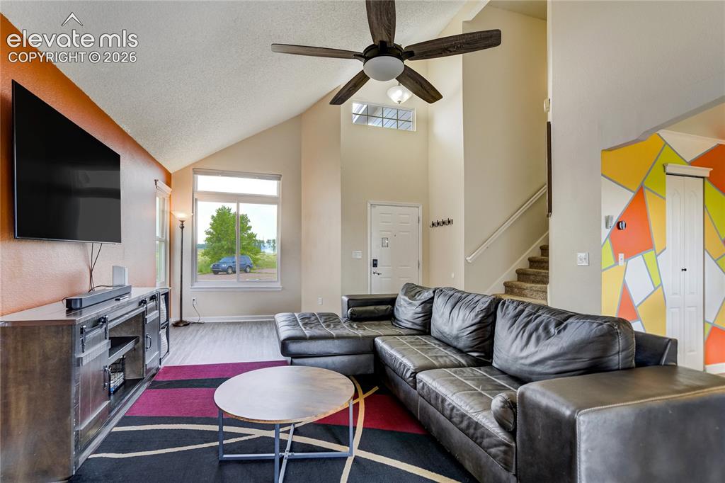 Image 5 of 40: Spacious living area featuring a vaulted ceiling with a ceiling fan, recess