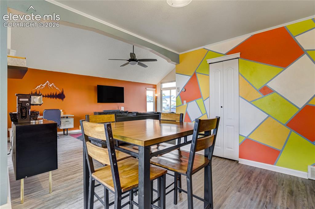 Image 8 of 40: Wood-finish flooring throughout, complemented by a geometric accent wall fe