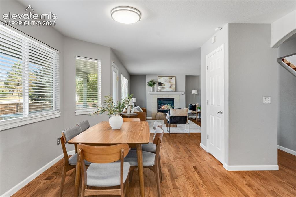 Image 15 of 36: Interior featuring wood-finish flooring, a fireplace with a mantel, multipl