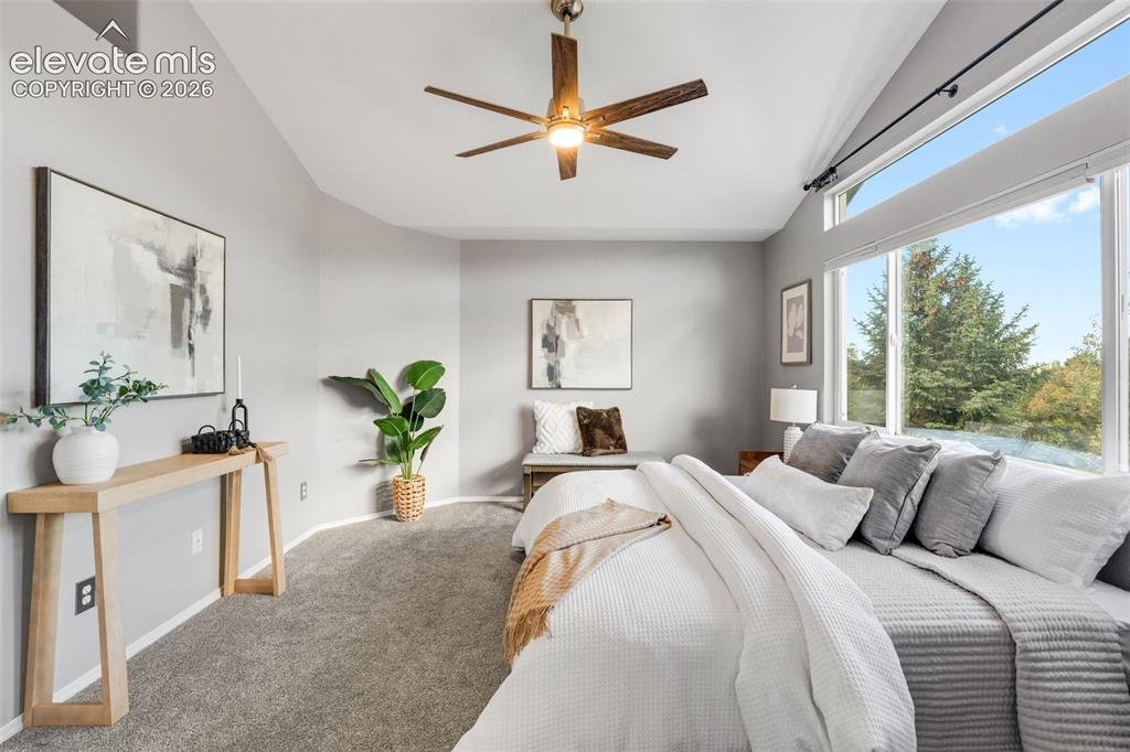 Image 19 of 36: Vaulted ceilings featuring a multi-blade wood-finish ceiling fan with integ