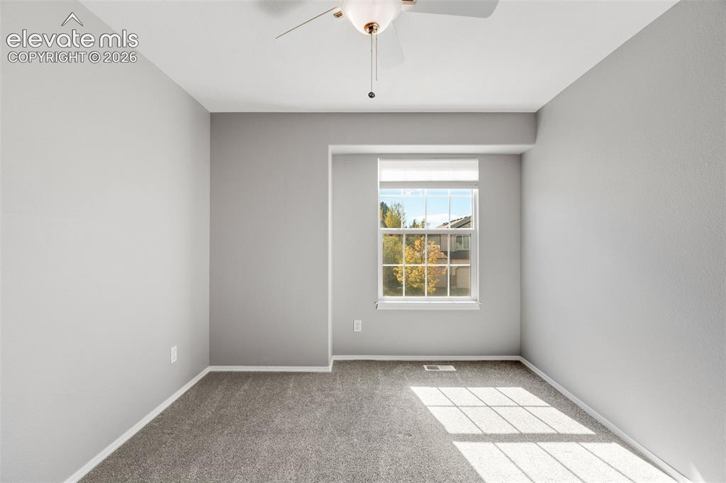 Image 23 of 36: Neutral-toned room featuring wall-to-wall carpeting, a recessed window, and
