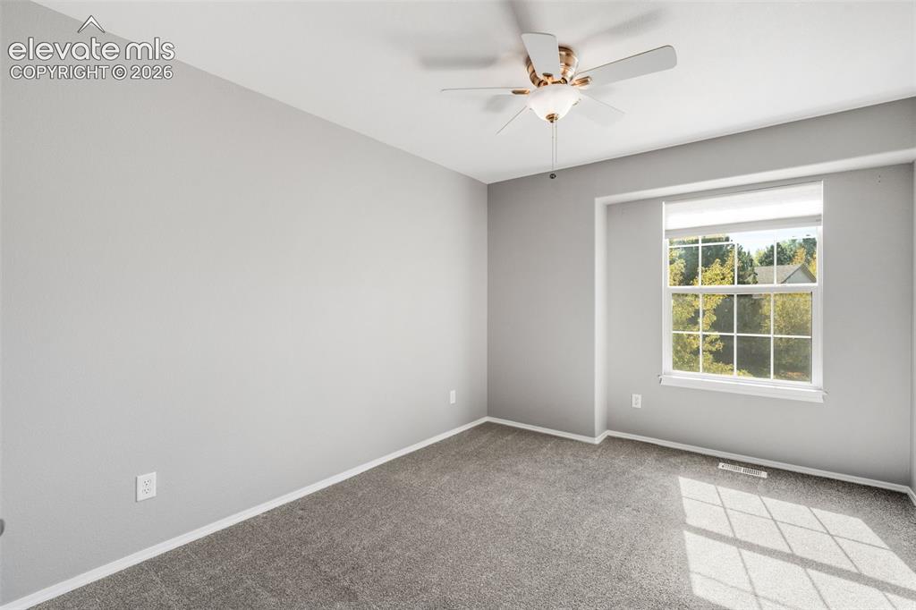 Image 24 of 36: Room featuring neutral wall tones, plush wall-to-wall carpeting, a multi-pa
