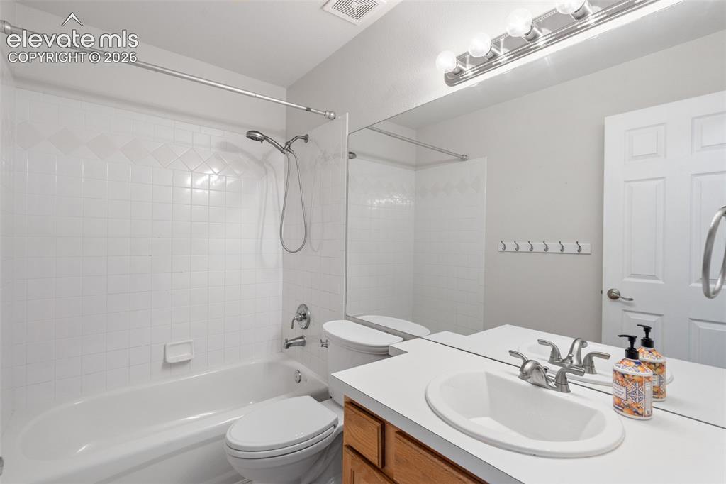 Image 26 of 36: Full-width vanity featuring an integrated sink, polished chrome faucet, exp