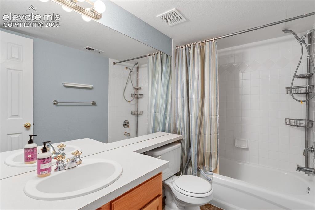 Image 31 of 36: Bathroom featuring a vanity with an integrated countertop, oval sink, chrom