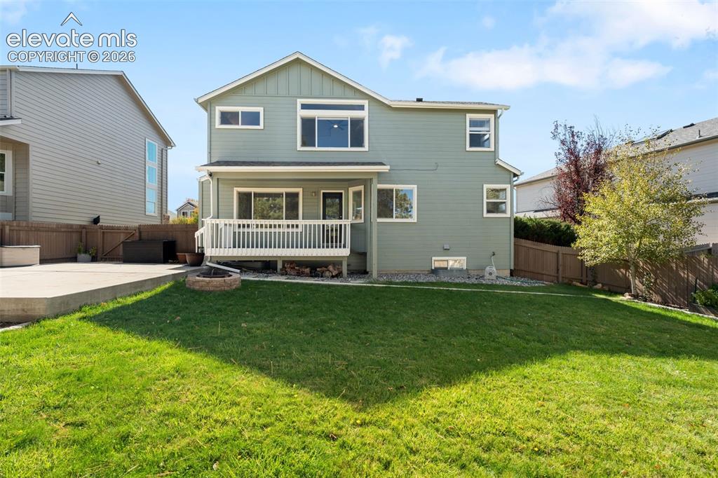 Image 32 of 36: Two-story exterior featuring horizontal siding, a raised rear deck with bal
