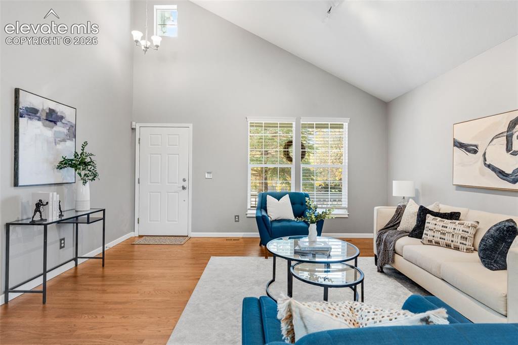 Image 5 of 36: Vaulted ceilings, wood-finish flooring, dual-pane windows, and a high-place