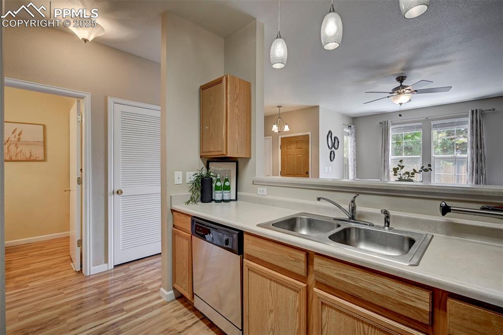 Image 11 of 26: Kitchen featuring stainless steel dishwasher, a sink, light wood-type floor