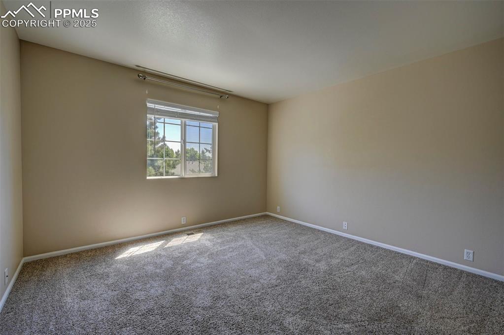 Image 19 of 26: Carpeted empty room featuring baseboards