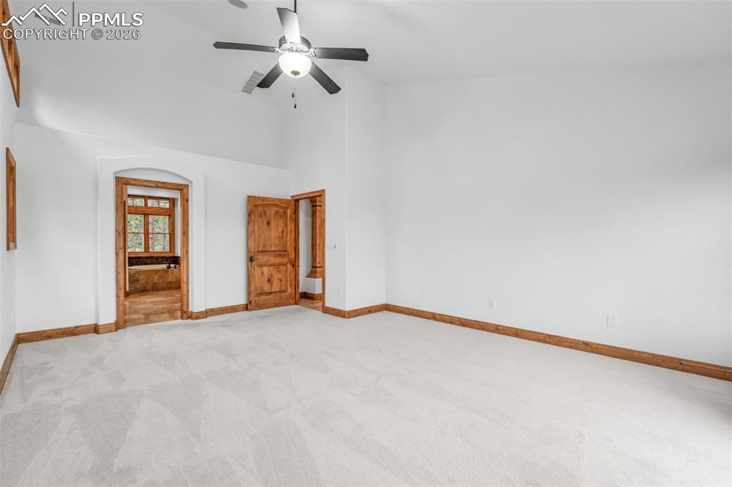 Image 23 of 50: Walkout to deck dramatic Vaulted Cathredal Ceiling with Beams