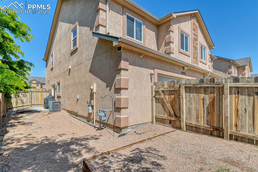 Image 25 of 28: Larger fenced in side yard with access to driveway and attached 2 car garag