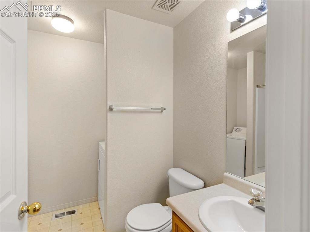 Image 14 of 30: Full bath with laundry room, upstairs