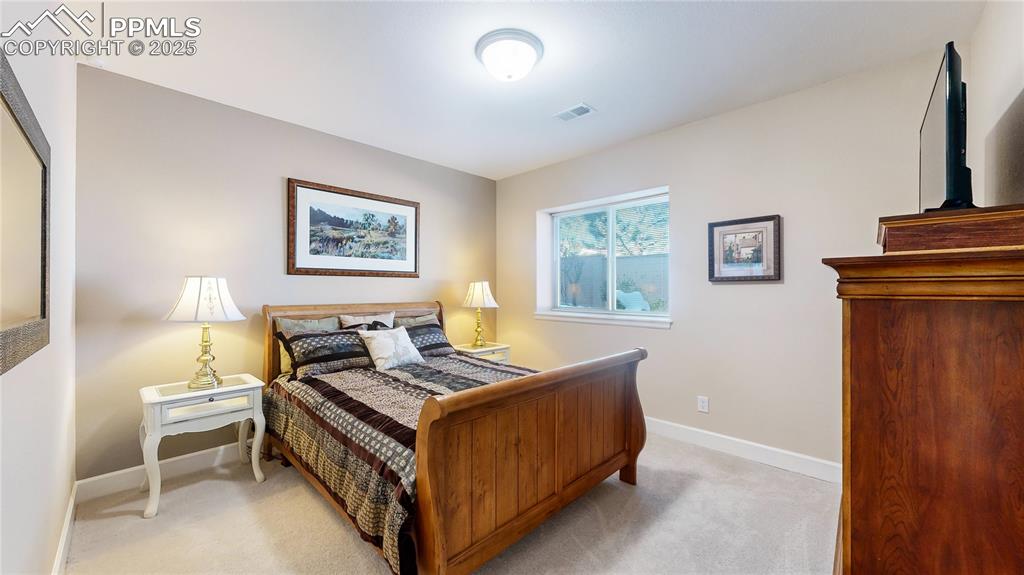 Image 18 of 34: Bedroom with light carpet and baseboards