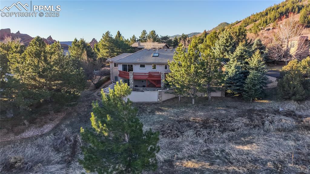 Image 25 of 34: Rear view of property featuring a tiled roof, a deck with mountain view, an