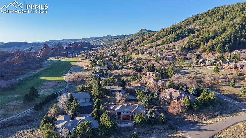Image 26 of 34: Aerial view of residential area featuring a mountain backdrop