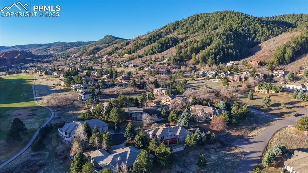Image 29 of 34: View of property location featuring a mountain backdrop and nearby suburban