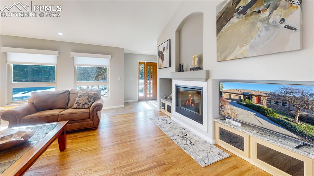 Image 3 of 34: Living room with light wood-style floors, a fireplace, recessed lighting, a