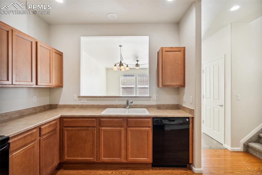 Image 12 of 28: Kitchen featuring dishwasher, light wood-style flooring, light countertops,