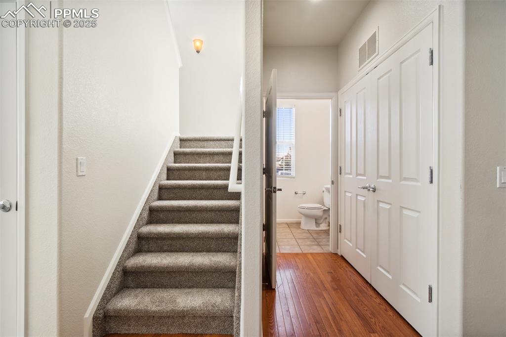 Image 15 of 28: Stairs featuring hardwood / wood-style flooring and baseboards
