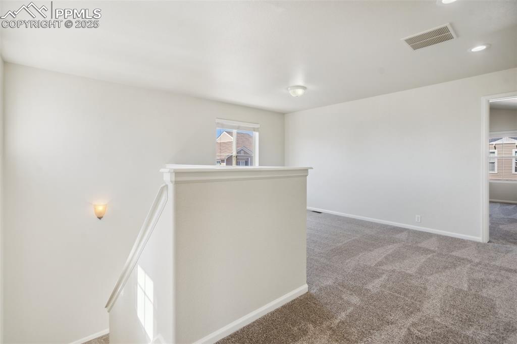 Image 18 of 28: Corridor featuring an upstairs landing, carpet, and recessed lighting