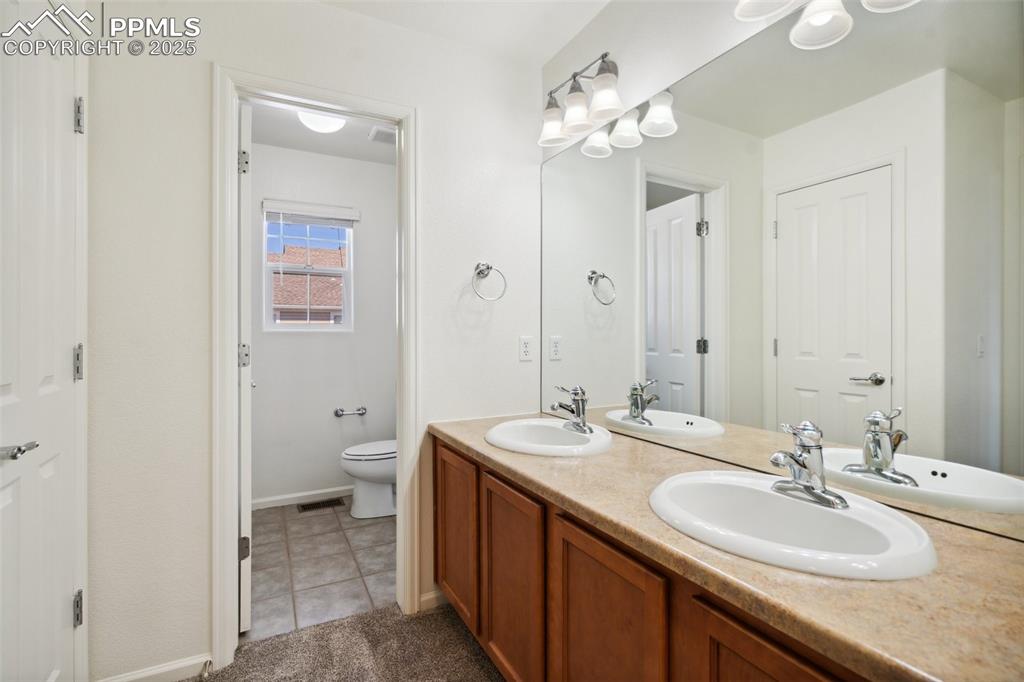 Image 22 of 28: Full bathroom featuring double vanity and tile patterned floors