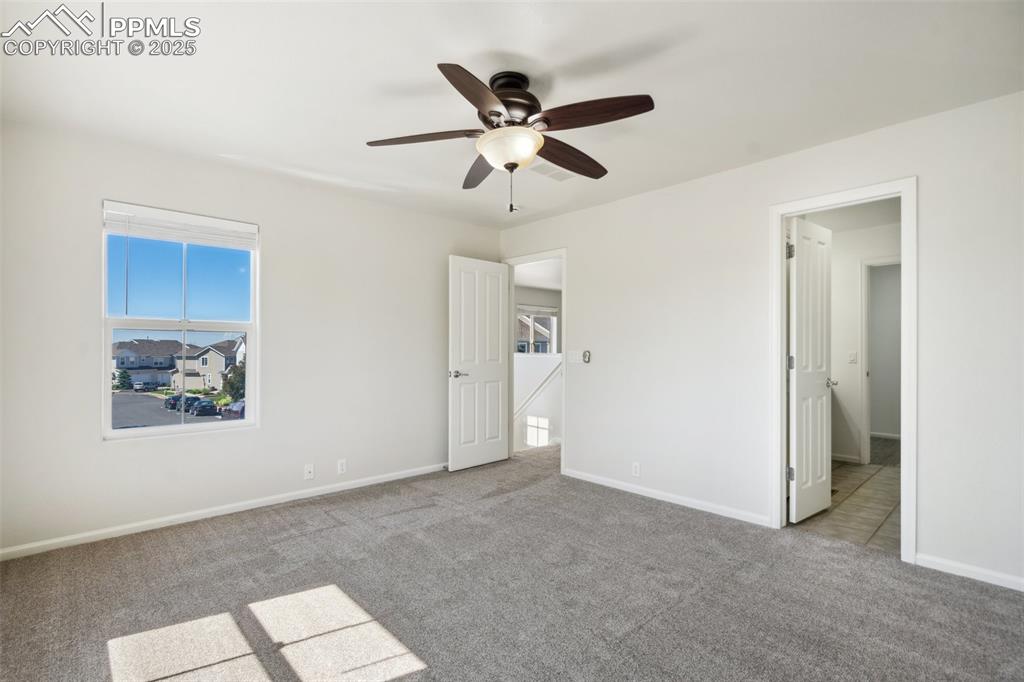 Image 26 of 28: Unfurnished bedroom featuring carpet and ceiling fan