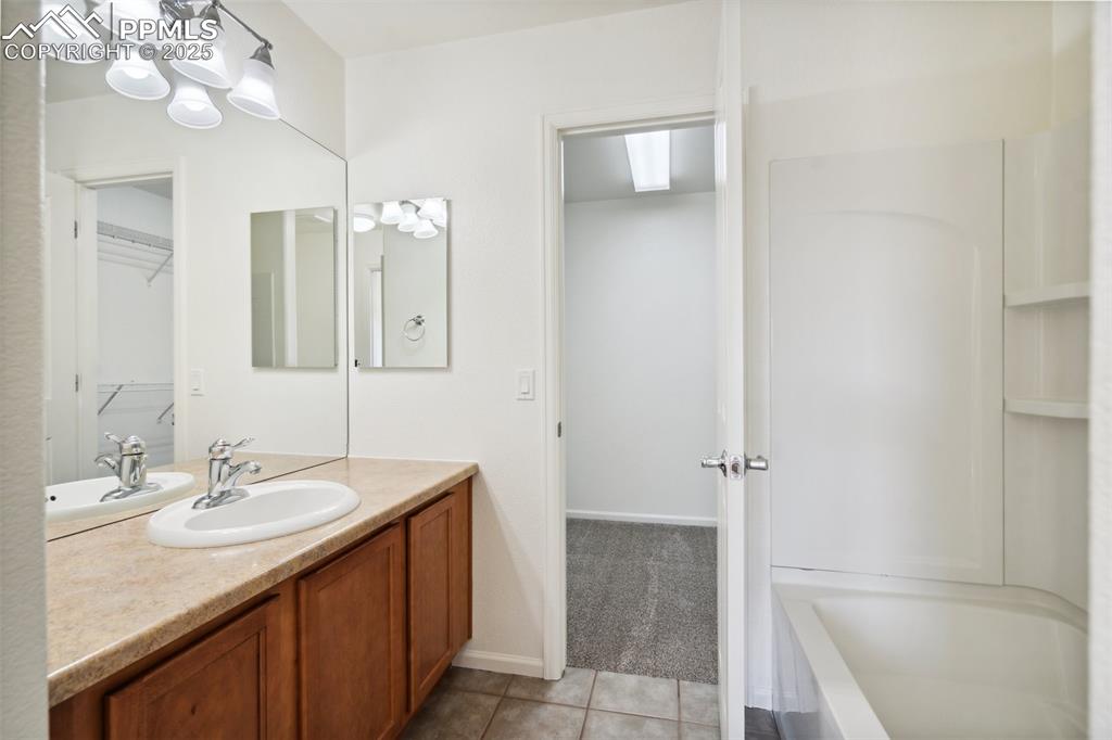 Image 27 of 28: Bathroom featuring vanity and tile patterned floors