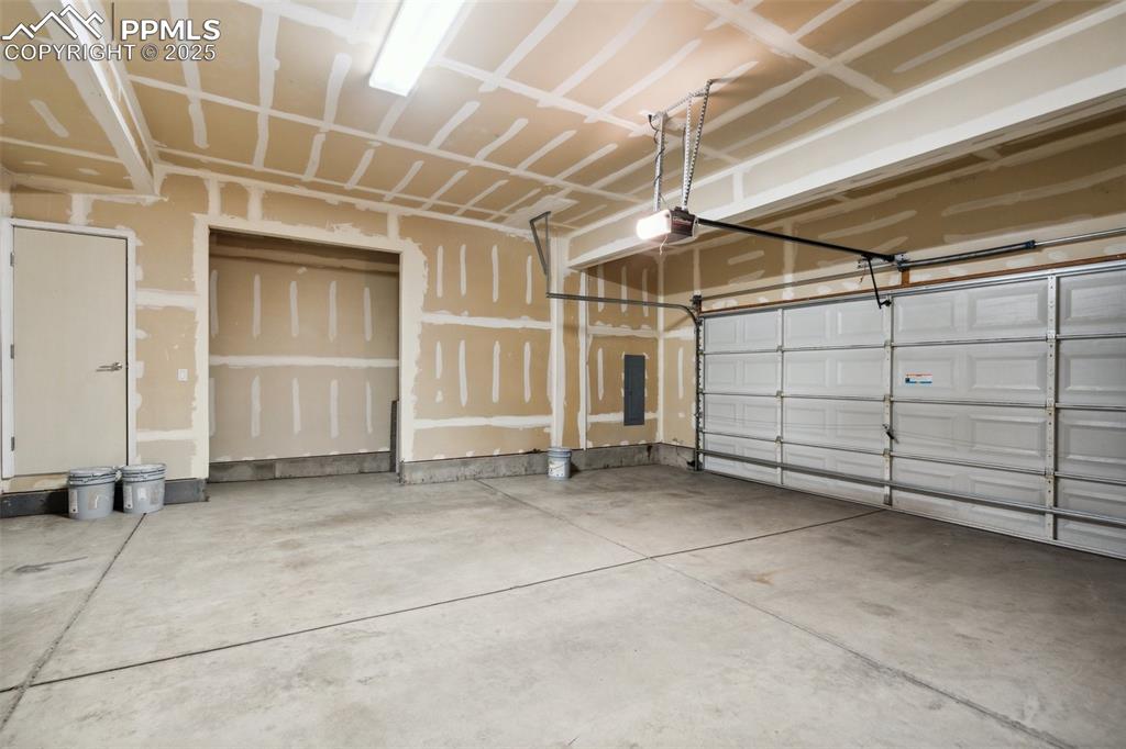 Image 28 of 28: Garage with a garage door opener