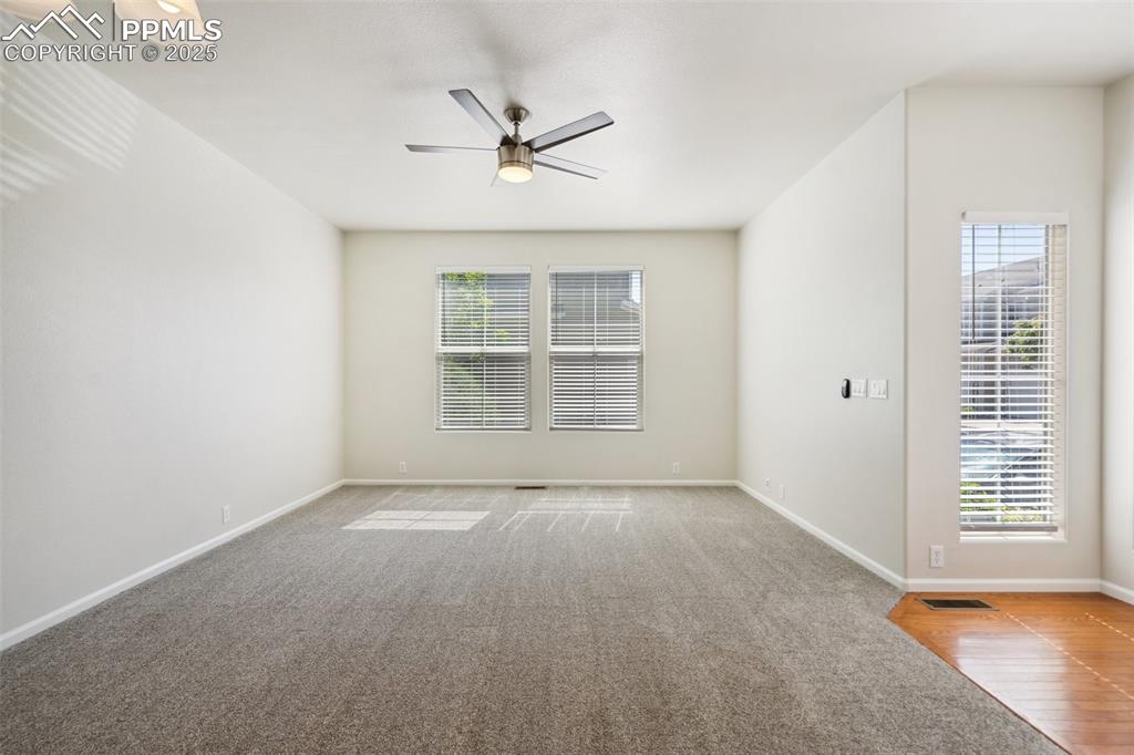 Image 4 of 28: Carpeted empty room featuring ceiling fan and baseboards