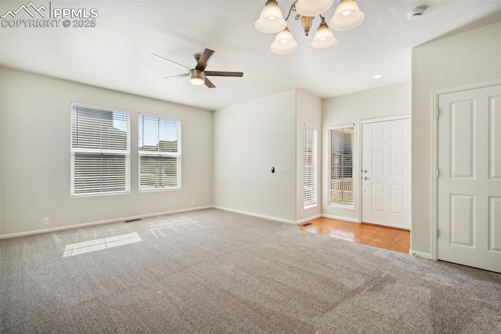 Image 5 of 28: Unfurnished bedroom featuring carpet floors, a chandelier, and ceiling fan