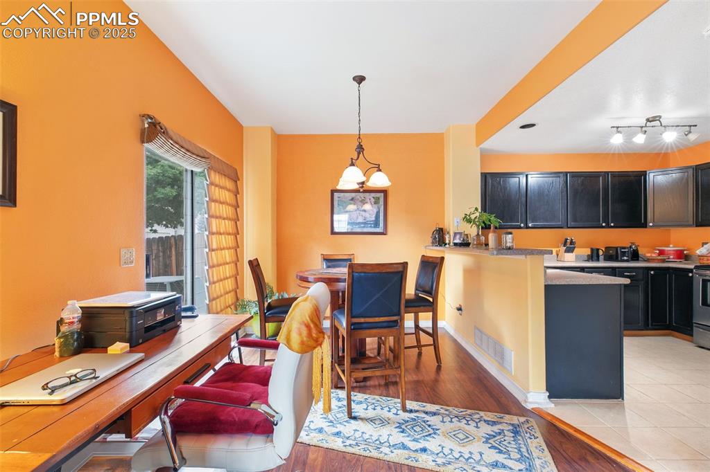 Image 10 of 29: Dining area featuring light wood finished floors and a desk