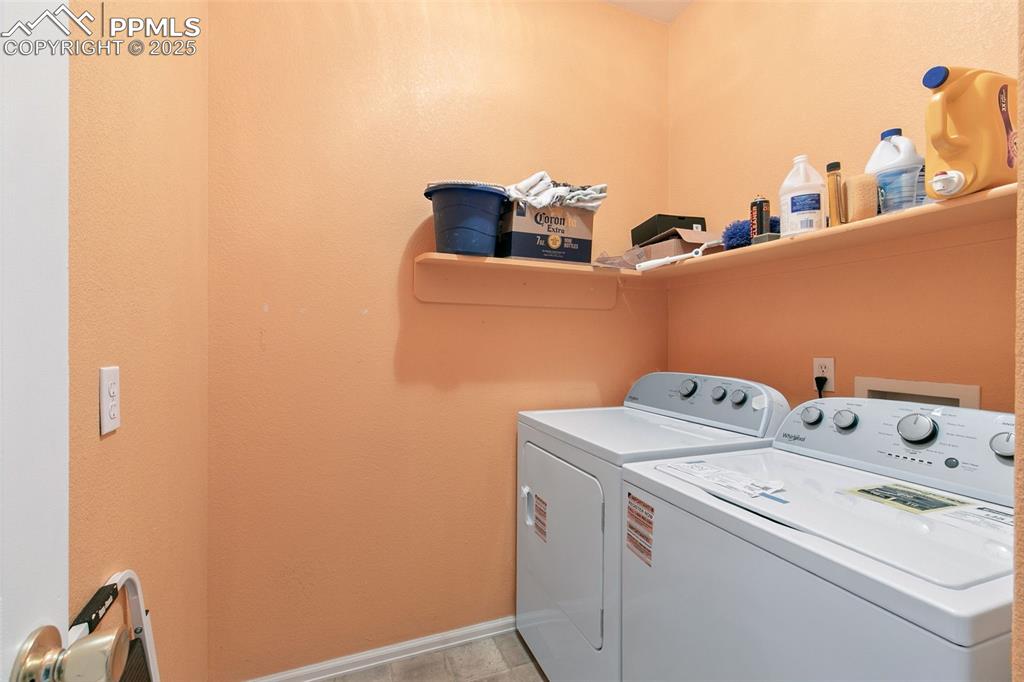 Image 15 of 29: Laundry area with washer and clothes dryer and a textured wall