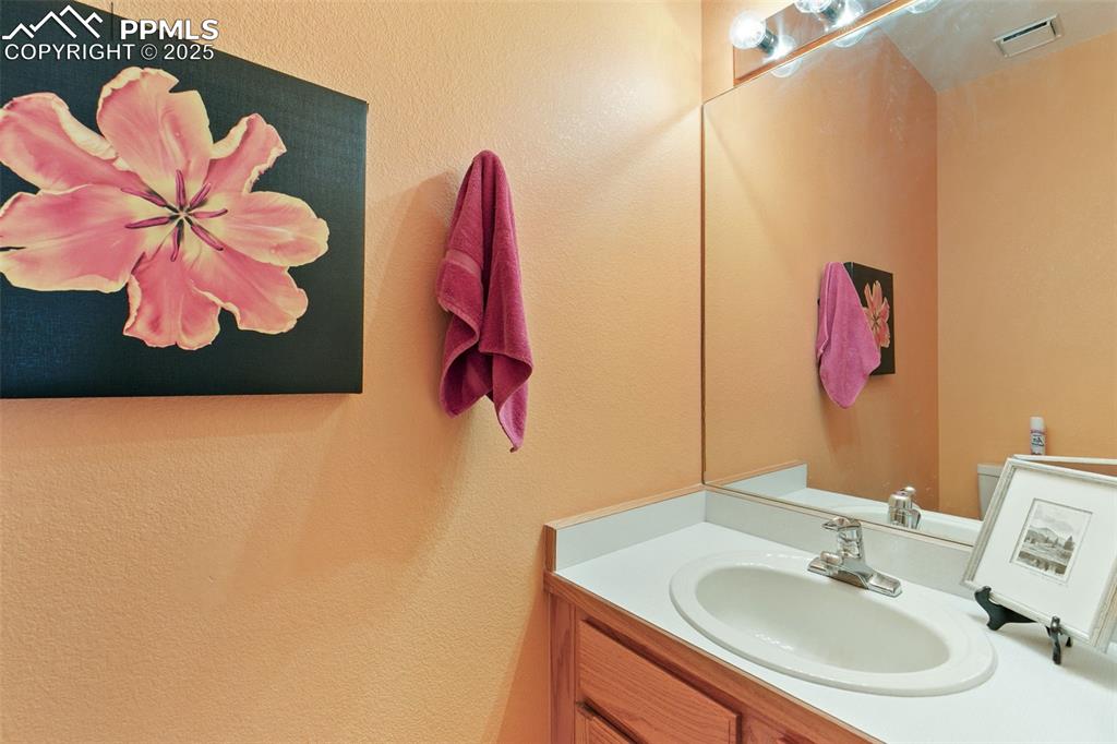 Image 16 of 29: Bathroom featuring vanity and a textured wall