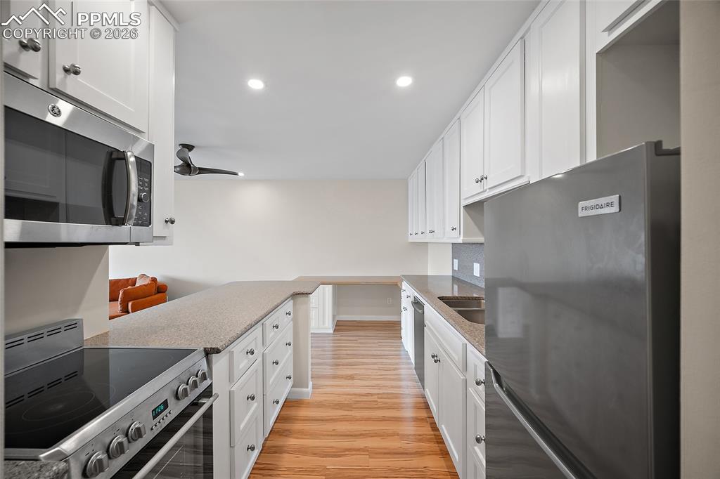 Image 3 of 41: Kitchen with Granite and Stainless Steel Appliances