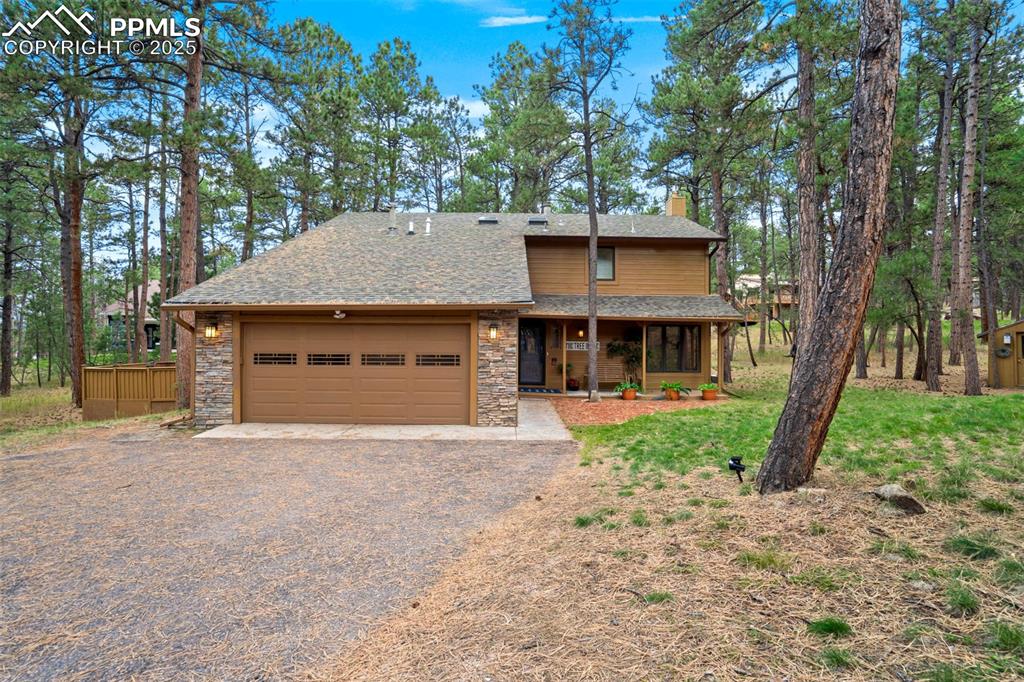 Image 2 of 48: View of front of property featuring driveway, a shingled roof, a chimney, a