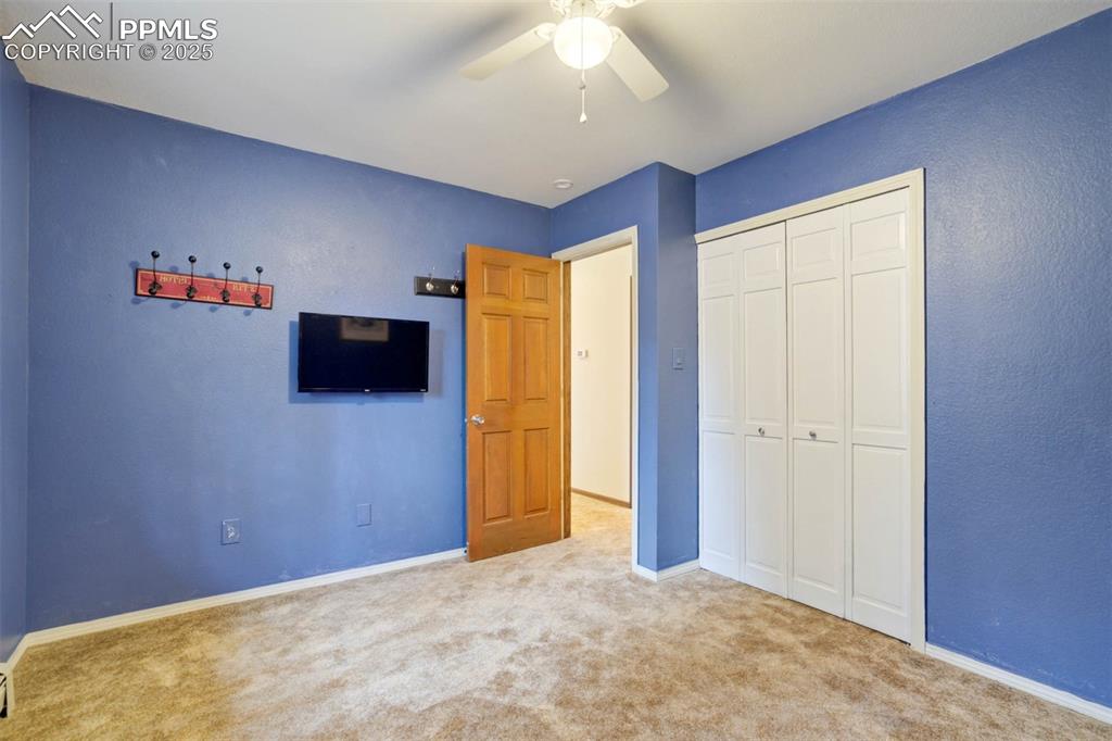 Image 22 of 48: Unfurnished bedroom featuring carpet floors, a closet, and ceiling fan