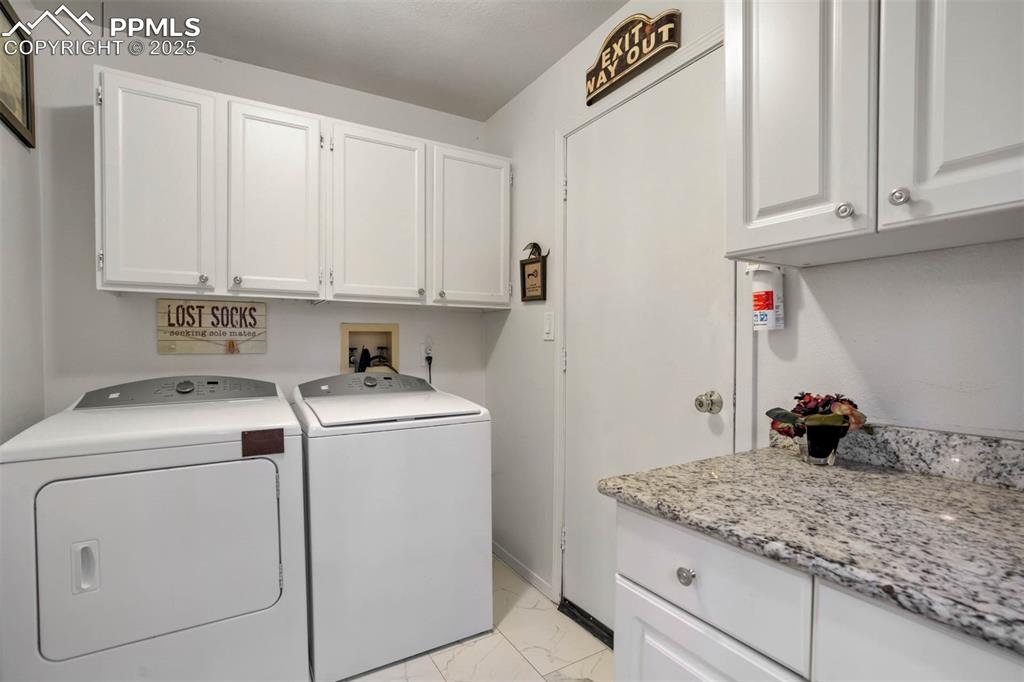 Image 32 of 48: Washroom featuring cabinet space, light marble finish flooring, and separat