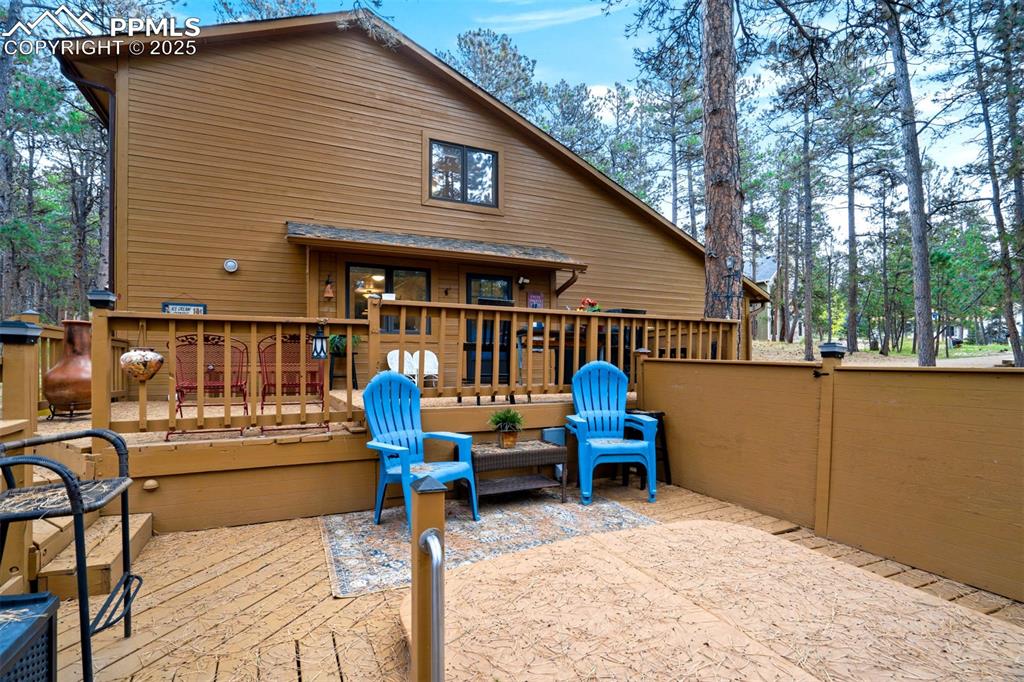 Image 34 of 48: Rear view of house featuring a wooden deck