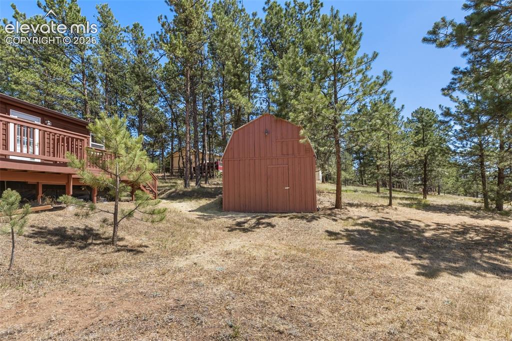 Image 13 of 22: Oversized shed with upper level storage.