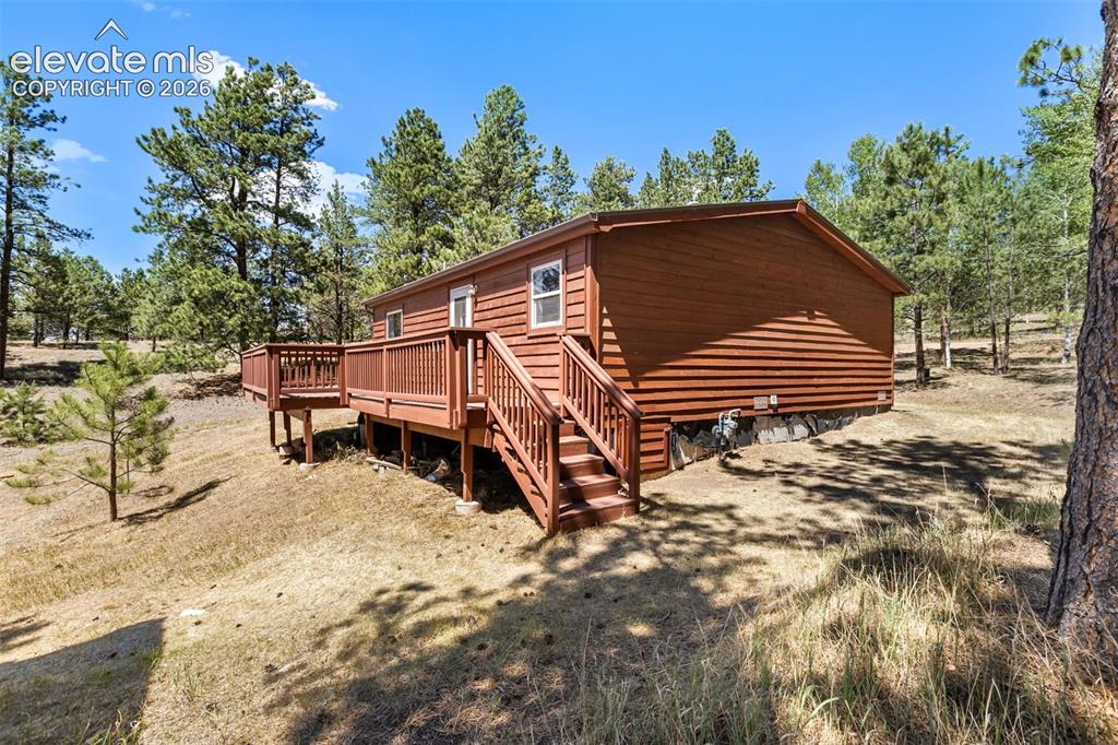 Image 14 of 22: Back of Property with deck