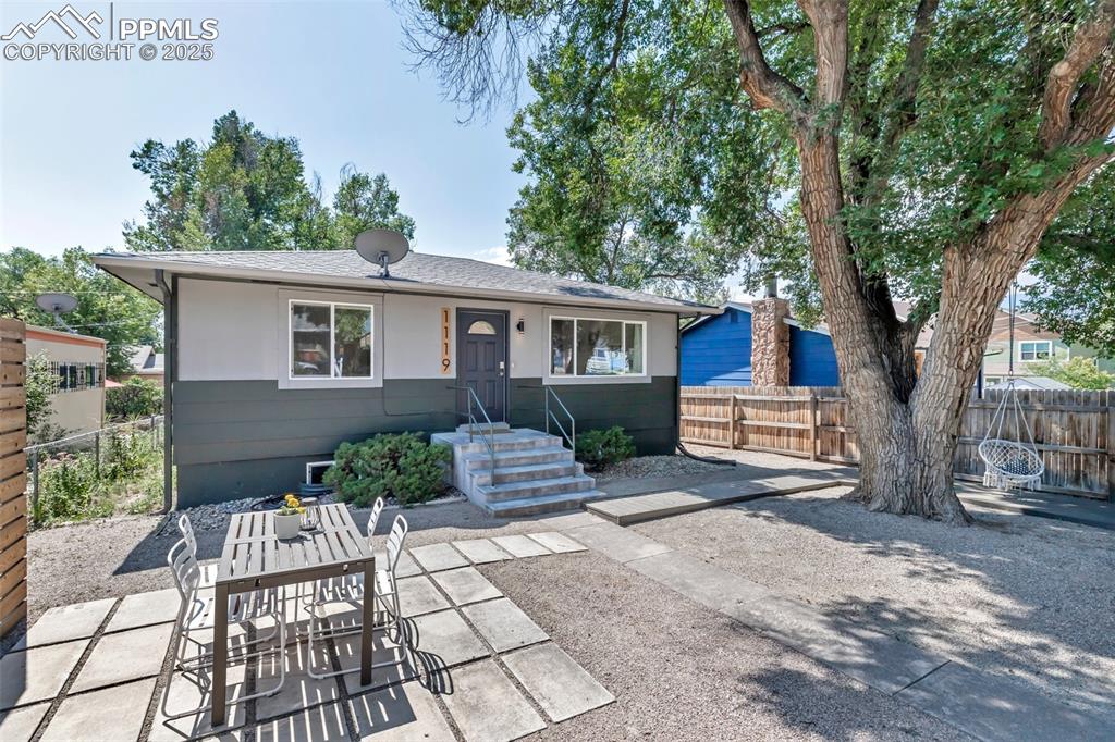 Caption: View of front of house with landscaped yard