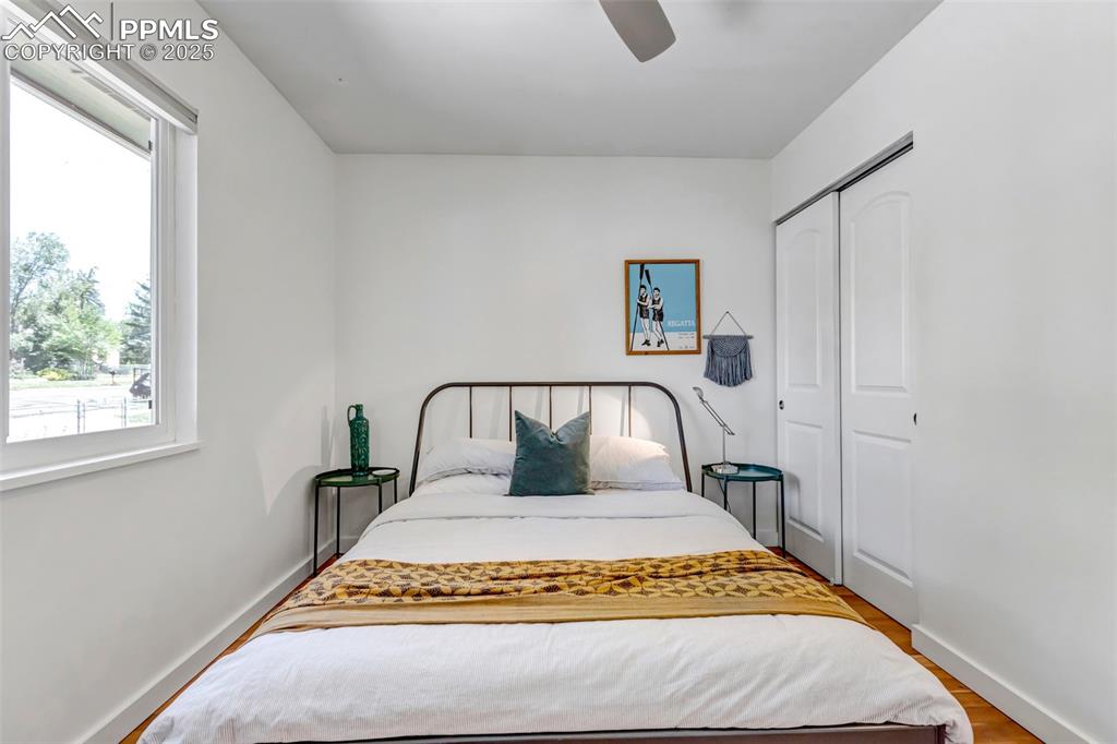 Image 13 of 35: Bedroom featuring a closet, wood finished floors, and ceiling fan