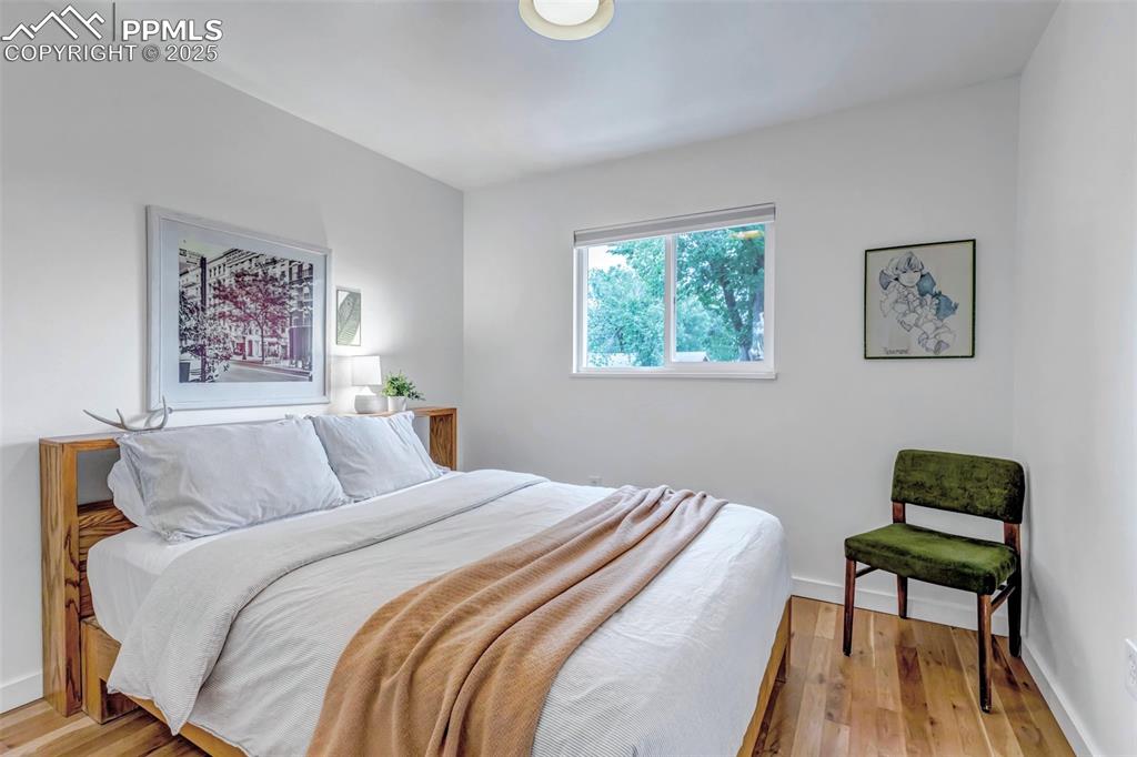 Image 15 of 35: Bedroom with light wood-style flooring and baseboards
