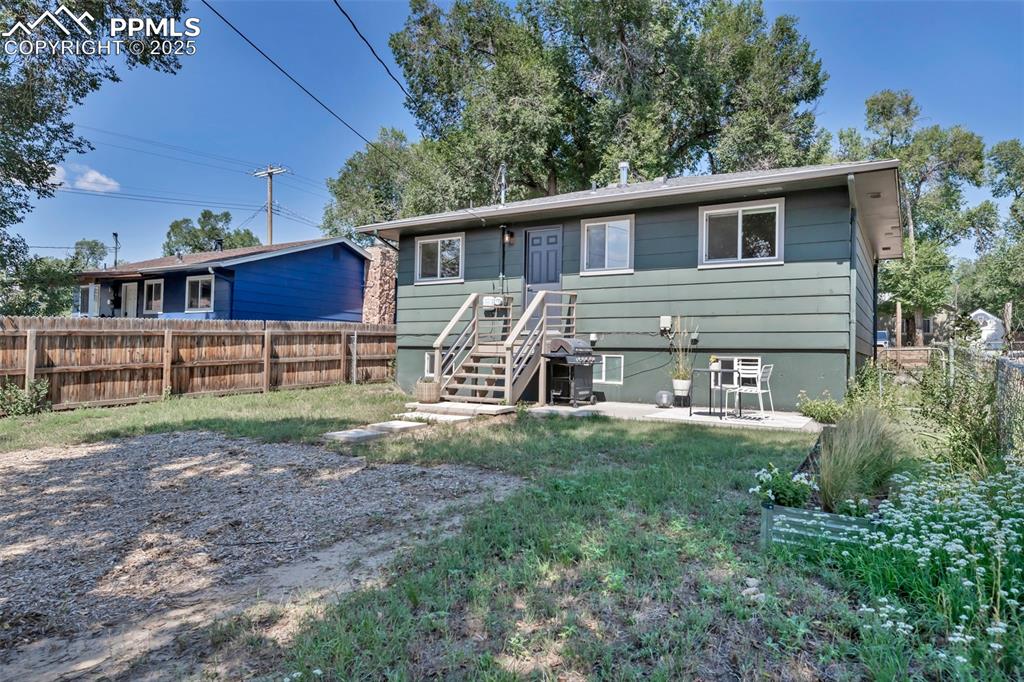 Image 26 of 35: Ranch-style home with a fenced backyard and a patio