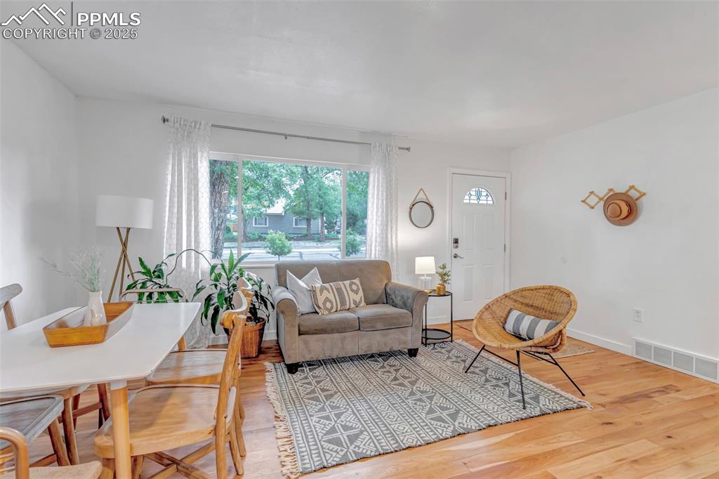 Image 3 of 35: Living area with wood finished floors and baseboards