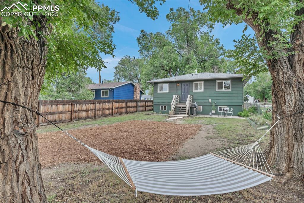 Image 30 of 35: Rear view of property with a fenced backyard