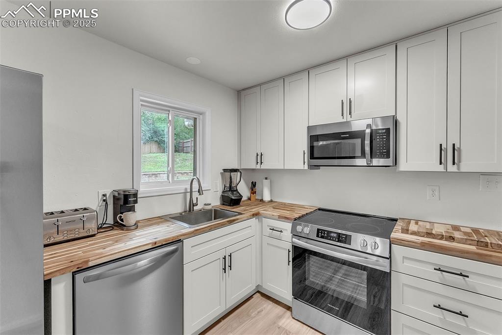 Image 10 of 38: Fully Updated Kitchen: Brand New Cabinetry w/ Solid Butcher Block Counterto
